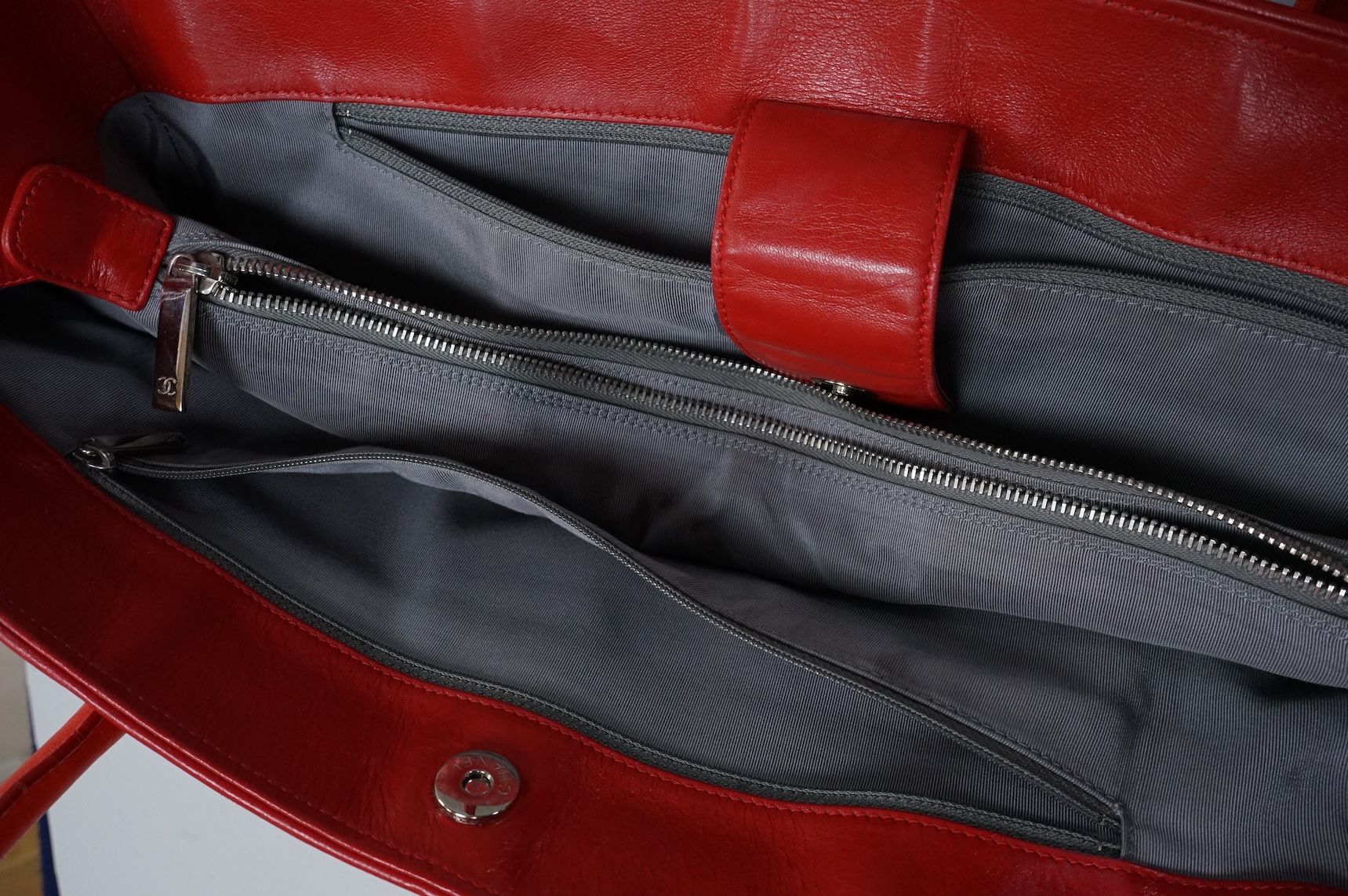 A Chanel red leather Executive Cerf tote bag with silver hardware, with original receipt and dust cover, 41cm wide, Provenance: Purchased by the vendor in Dubai, Chanel